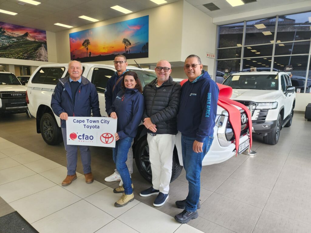 CEO of Marine Dynamics and Founder of the Dyer Island Conservation Trust, Wilfred Chivell, with his team and Andre Breytenbach, Dealer Principal of Cape Town City Toyota. 